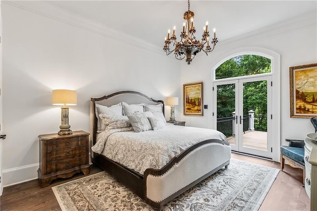 bedroom featuring baseboards, wood finished floors, access to outside, crown molding, and french doors