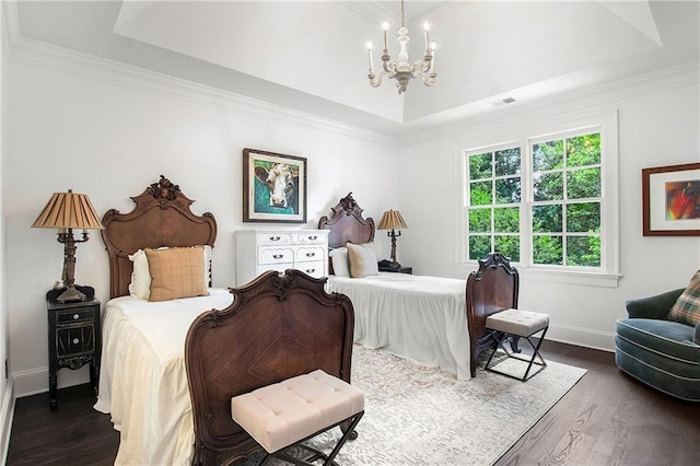 bedroom with a chandelier, a tray ceiling, visible vents, and dark wood-type flooring