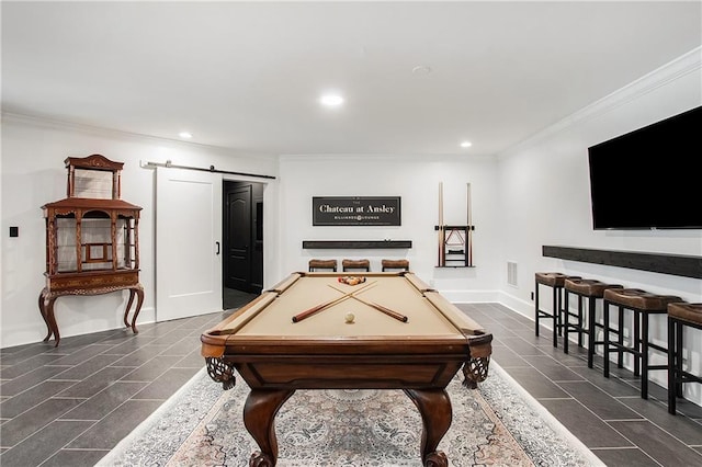 game room with dark tile patterned flooring, visible vents, crown molding, and a barn door