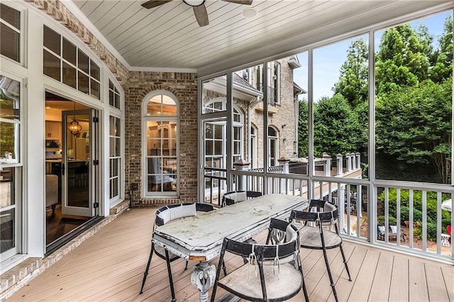 sunroom / solarium with wooden ceiling and a ceiling fan