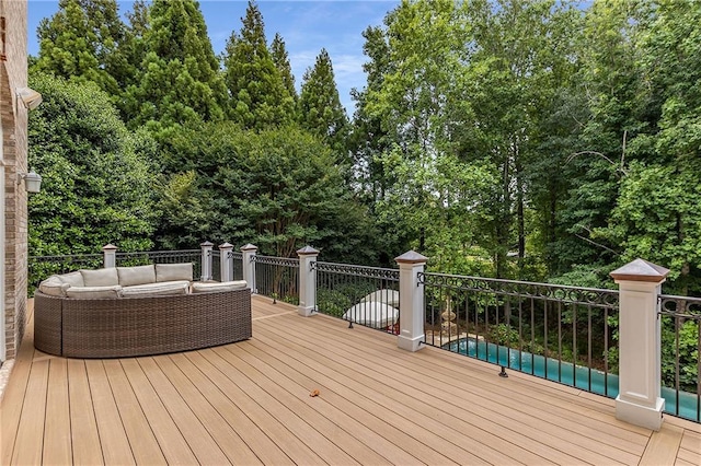 wooden terrace with an outdoor pool