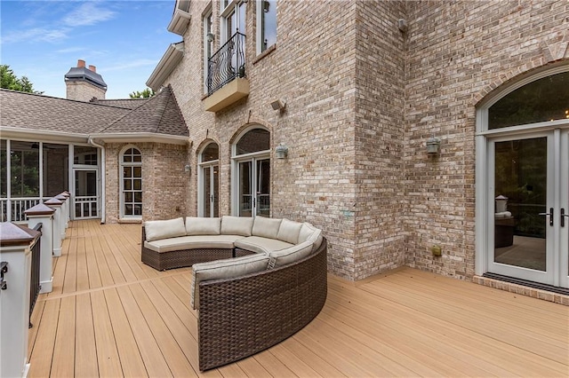 deck with french doors and an outdoor living space