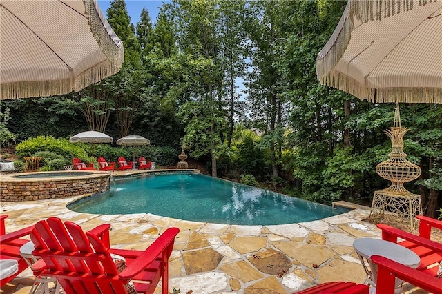 view of swimming pool featuring a patio area and a pool with connected hot tub