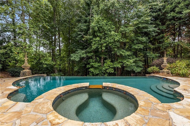 view of swimming pool featuring a pool with connected hot tub