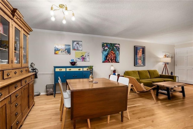 1177 Church St # A, Decatur, GA 30030 - dining room featuring crown molding, light wood-style floors, a textured ceiling, baseboards, and a chandelier