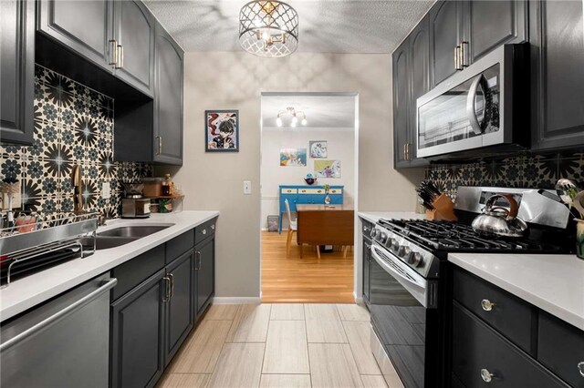1177 Church St # A, Decatur, GA 30030 - kitchen with stainless steel appliances, decorative backsplash, light countertops, and a textured ceiling