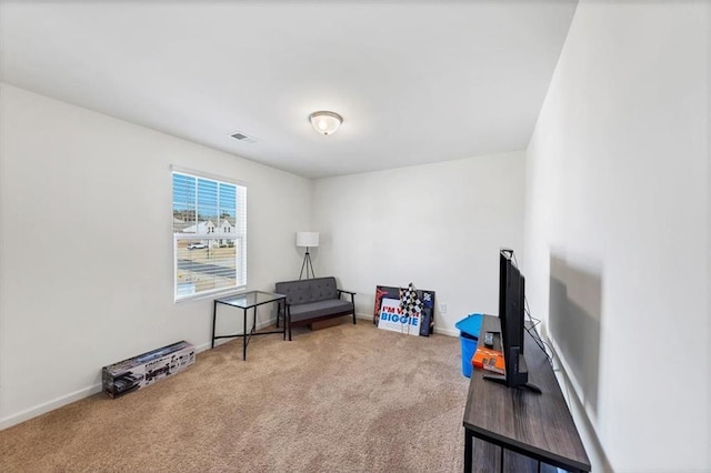 sitting room with carpet flooring and baseboards