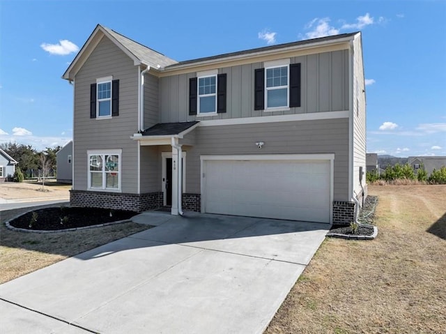 traditional home with board and batten siding, brick siding, driveway, and an attached garage