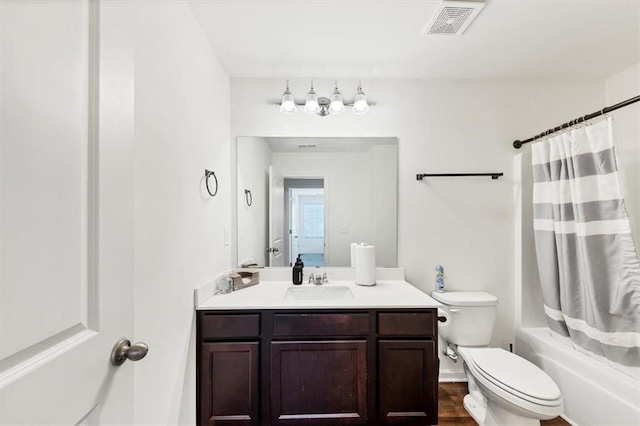 bathroom featuring visible vents, toilet, wood finished floors, shower / bathtub combination with curtain, and vanity