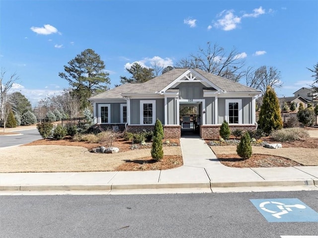 craftsman house featuring board and batten siding and brick siding