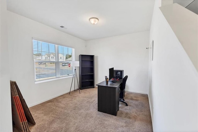 office space with visible vents, baseboards, and light colored carpet