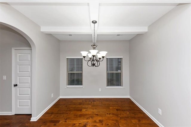 empty room with coffered ceiling, a notable chandelier, dark hardwood / wood-style flooring, and beamed ceiling