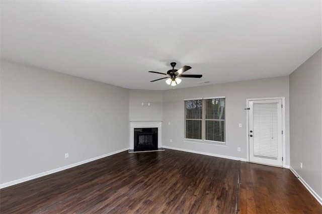 unfurnished living room with ceiling fan and dark hardwood / wood-style flooring