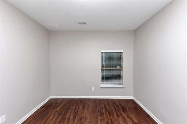 unfurnished room with hardwood / wood-style flooring