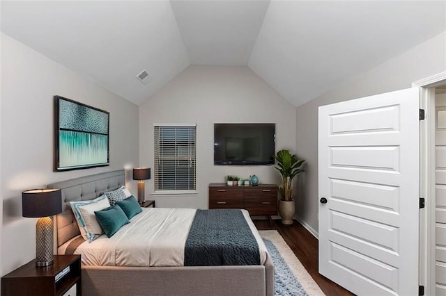 bedroom with lofted ceiling and dark wood-type flooring