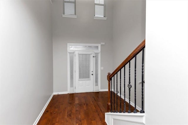 entryway with dark hardwood / wood-style flooring