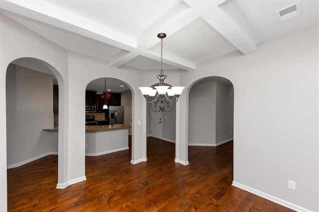 unfurnished dining area with beamed ceiling, coffered ceiling, dark hardwood / wood-style floors, and a chandelier