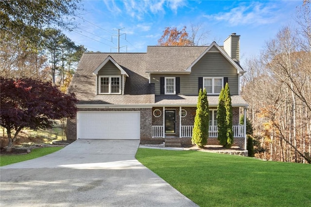 view of front facade featuring a porch, a garage, and a front lawn