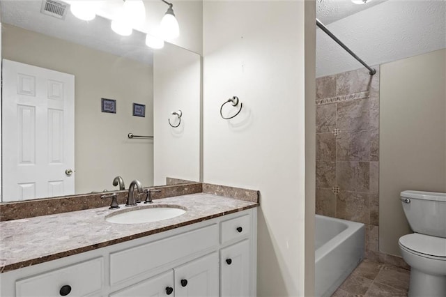 full bathroom featuring a textured ceiling, vanity, shower / bath combination, and toilet