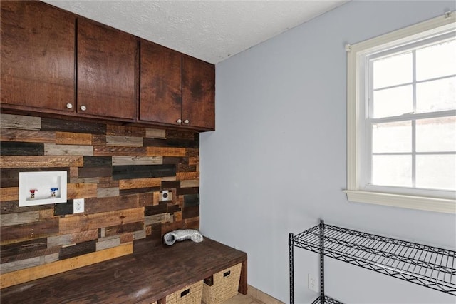 interior space featuring a textured ceiling and wooden walls