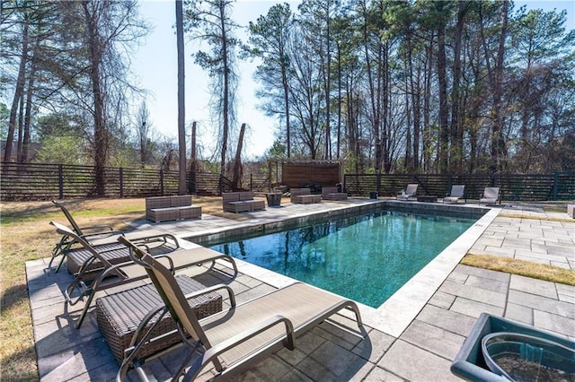 view of swimming pool featuring a fenced in pool, a patio, a fenced backyard, and outdoor lounge area