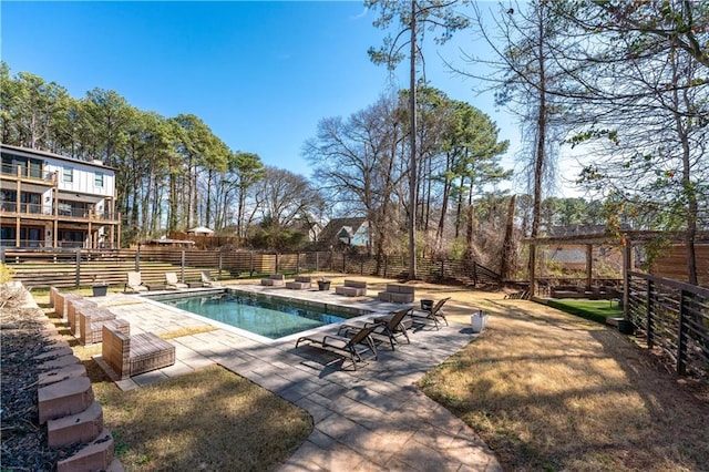 view of pool featuring a patio area, a fenced in pool, and fence