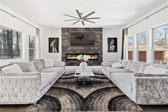 living area featuring a ceiling fan, recessed lighting, and a tile fireplace