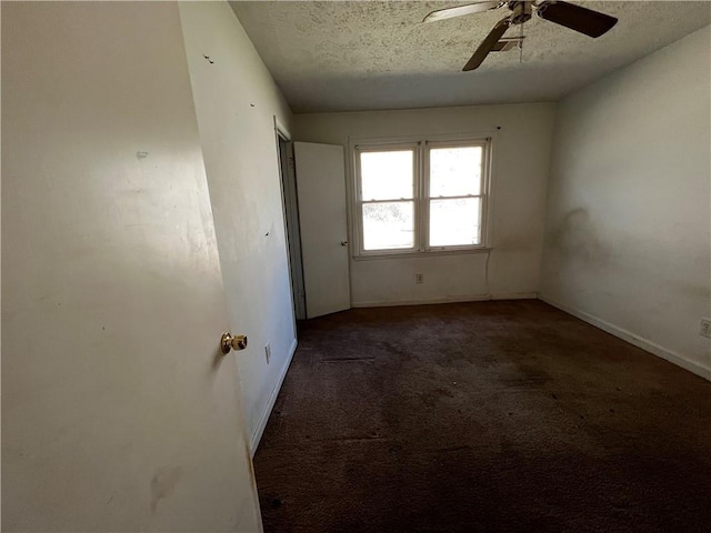 carpeted spare room with ceiling fan and a textured ceiling