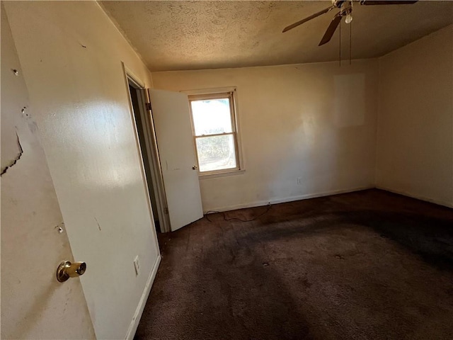 carpeted spare room with ceiling fan and a textured ceiling