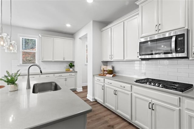 kitchen featuring a sink, light countertops, white cabinetry, and stainless steel appliances