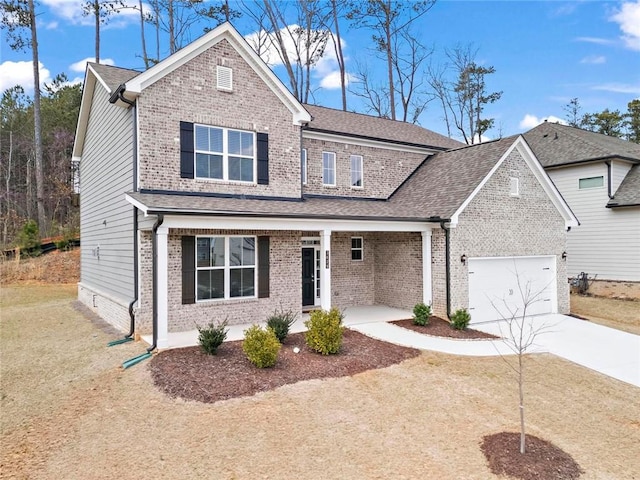 traditional home featuring an attached garage, brick siding, driveway, and a shingled roof