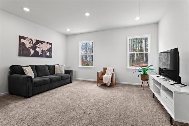 carpeted living room with recessed lighting and baseboards