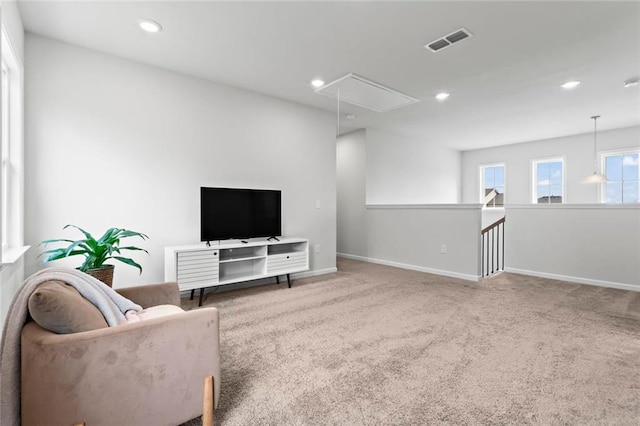 living room with visible vents, recessed lighting, attic access, and carpet floors