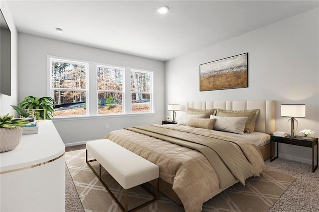 bedroom featuring light carpet and baseboards