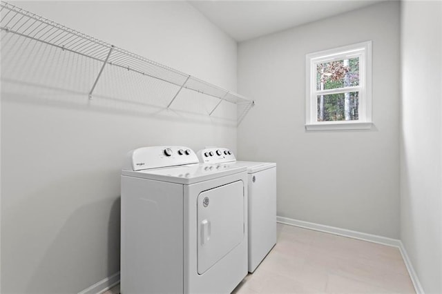 laundry area featuring laundry area, independent washer and dryer, and baseboards