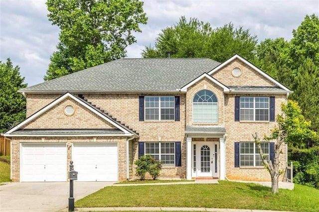 view of front of home with a front yard and a garage