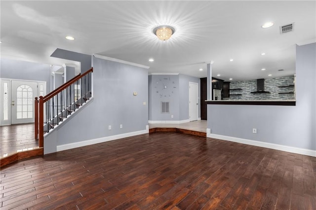 unfurnished living room featuring dark wood-type flooring and crown molding