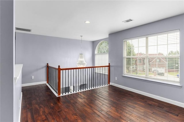 unfurnished room with dark hardwood / wood-style flooring