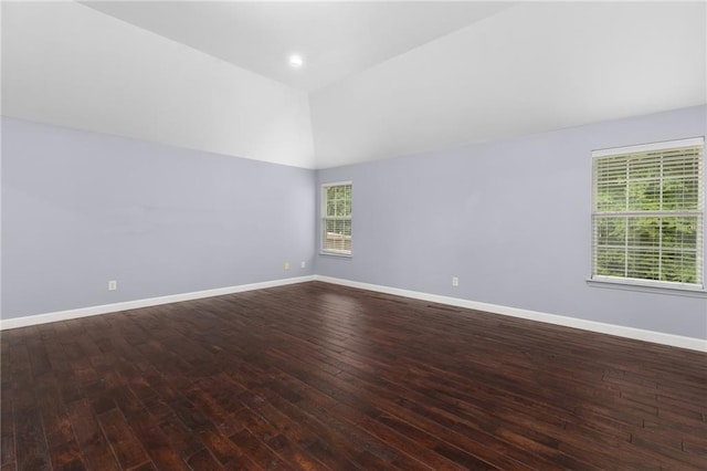 unfurnished room with wood-type flooring and vaulted ceiling