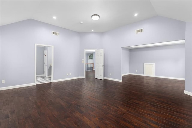 unfurnished living room featuring high vaulted ceiling and dark wood-type flooring