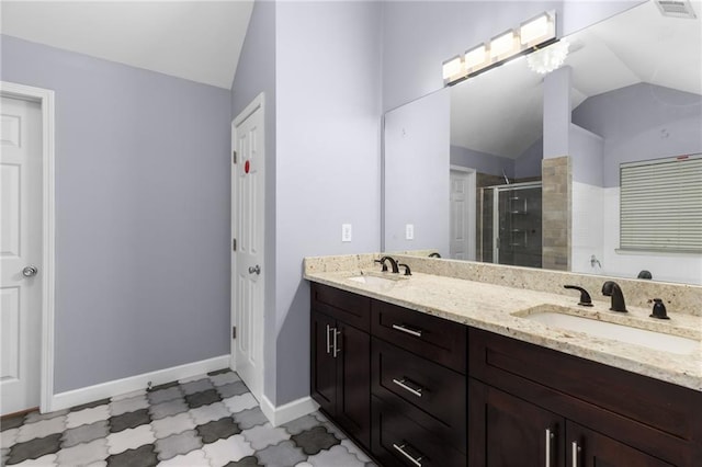 bathroom with an enclosed shower, vanity, and lofted ceiling