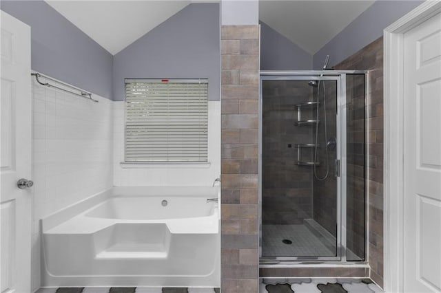 bathroom with shower with separate bathtub and vaulted ceiling