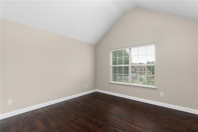 empty room featuring vaulted ceiling and wood-type flooring