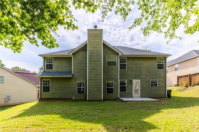 back of property with a patio area and a yard