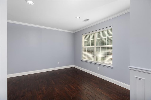 empty room featuring wood-type flooring and crown molding