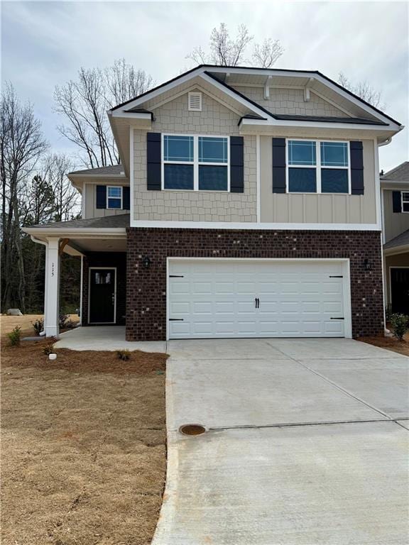 view of front of property with concrete driveway, brick siding, board and batten siding, and an attached garage