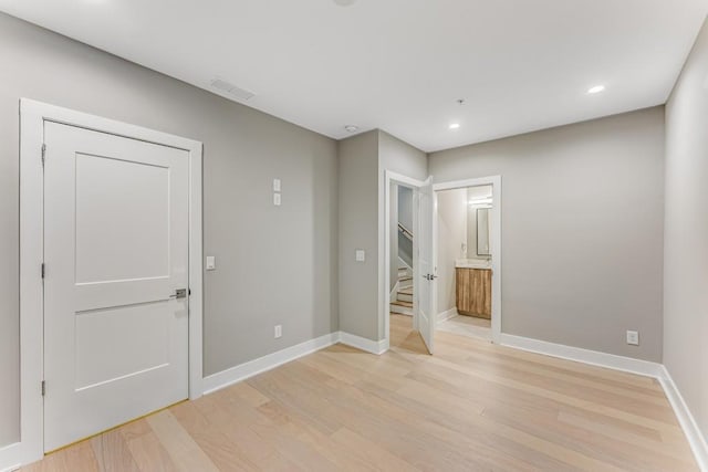 spare room with light hardwood / wood-style flooring