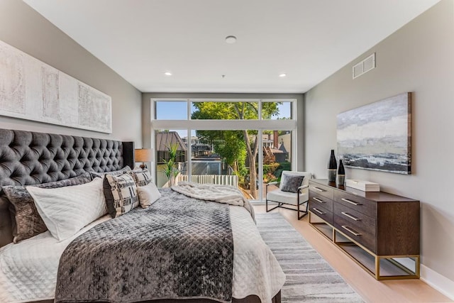 bedroom featuring access to exterior and light hardwood / wood-style floors