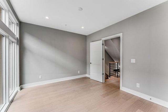 spare room featuring light hardwood / wood-style flooring