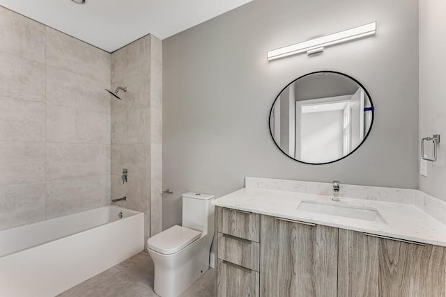 full bathroom featuring tile patterned floors, tiled shower / bath, vanity, and toilet